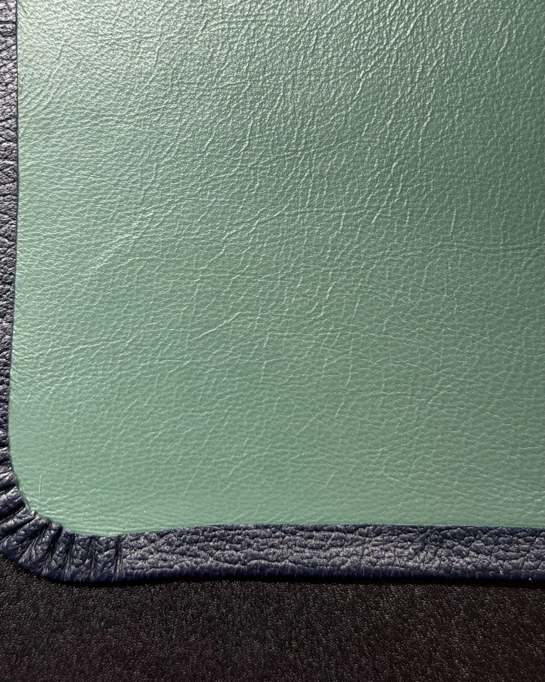 Green leather interior lining with hand-finished black corner
